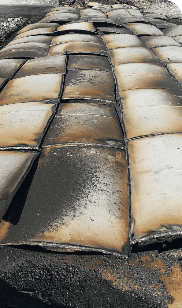 Neatly arranged torched scrap metal in a recycling yard